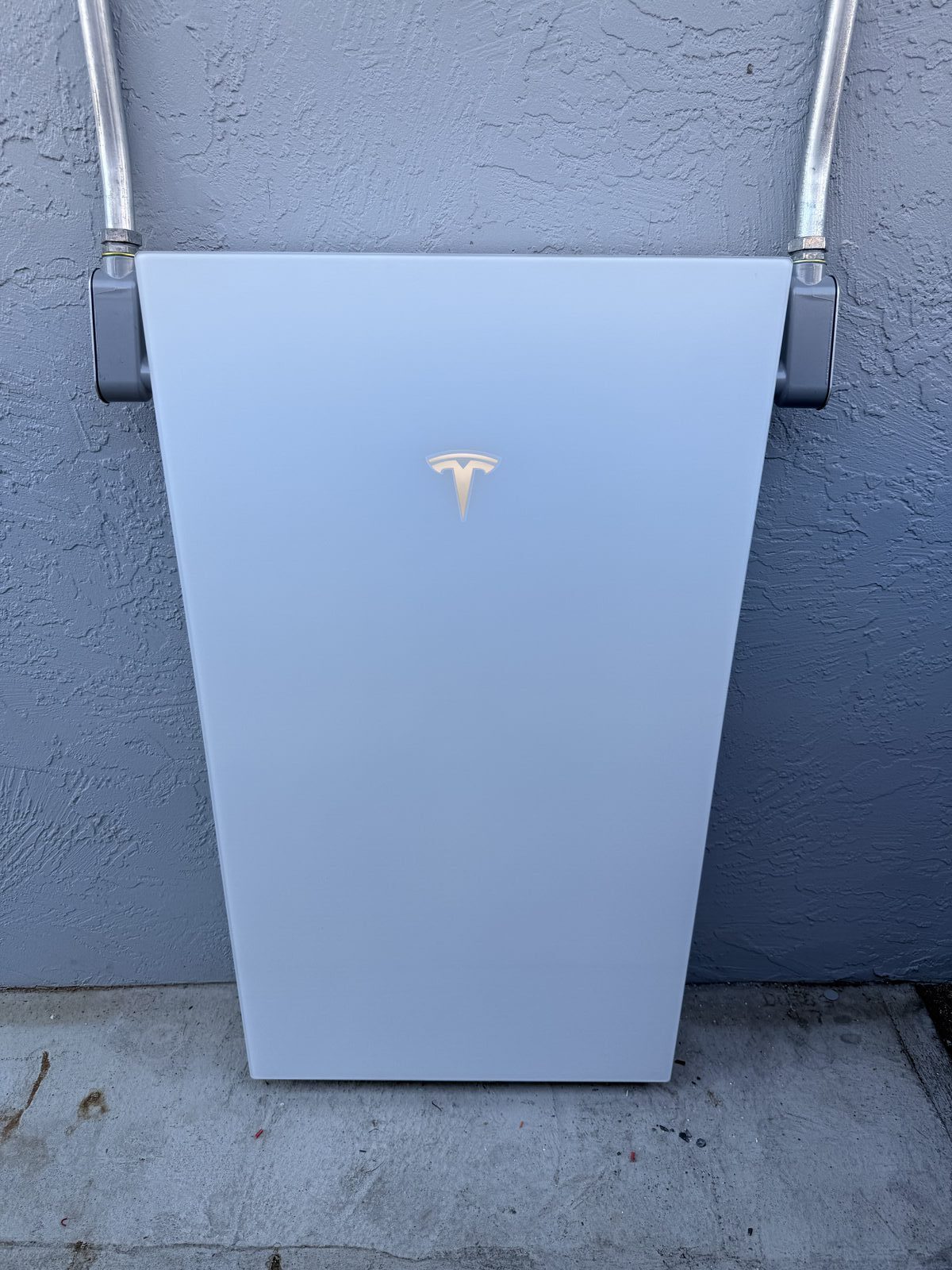 Tesla Powerwall 3 close-up showing unit face and conduit mounting brackets — Cyber Electric LLC
