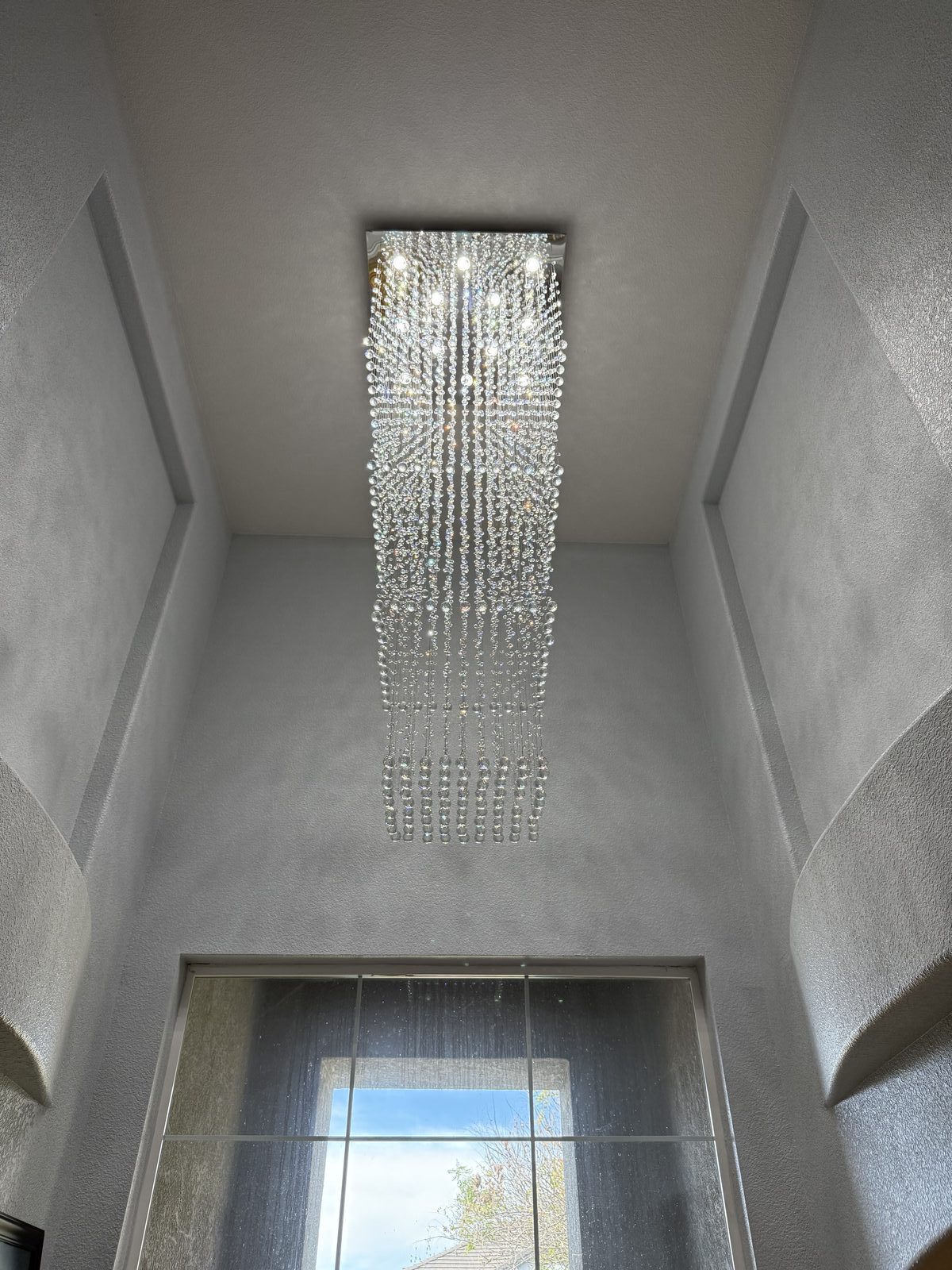 Large crystal chandelier installed in two-story foyer — Cyber Electric LLC, Modesto CA