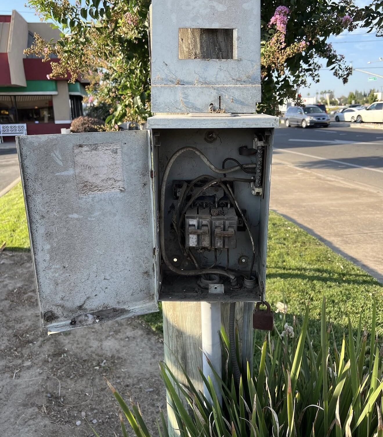Corroded deteriorated outdoor electrical panel on a wooden pole before replacement — Cyber Electric LLC, Modesto CA