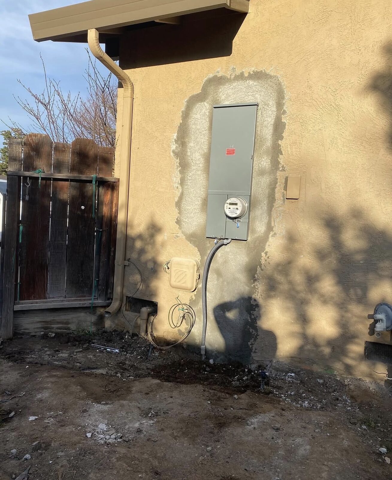 Finished exterior after Zinsco panel replacement — new panel and meter in stucco wall with fresh patch — Cyber Electric LLC, Modesto CA