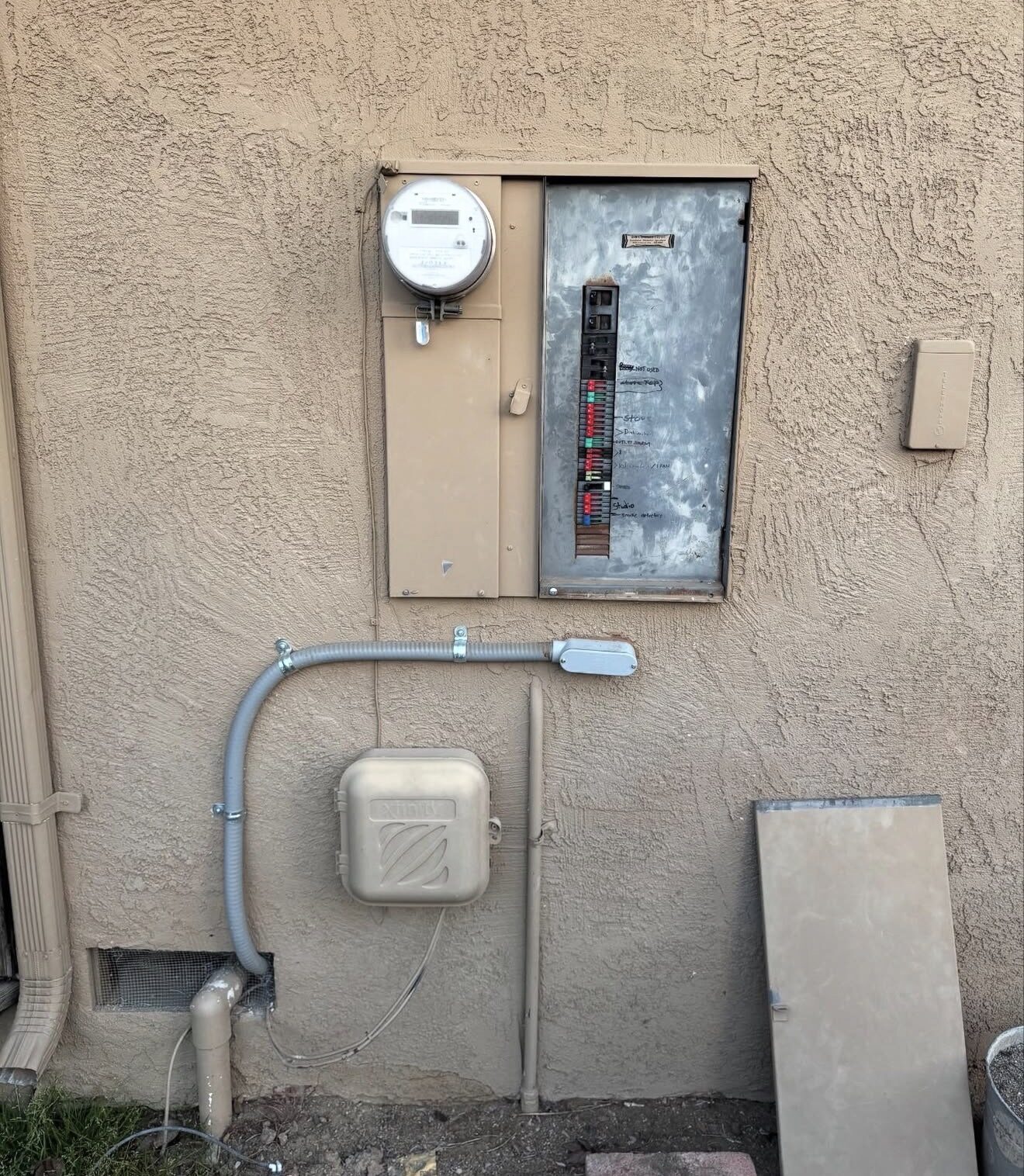Old Zinsco panel embedded in exterior stucco wall before removal — Cyber Electric LLC